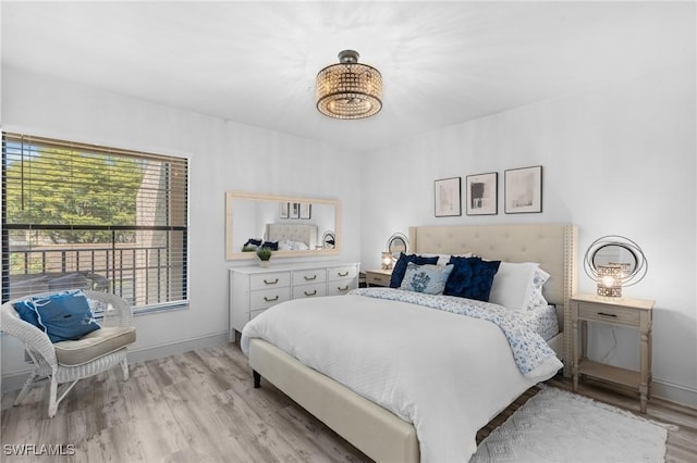 bedroom with wood finished floors and baseboards