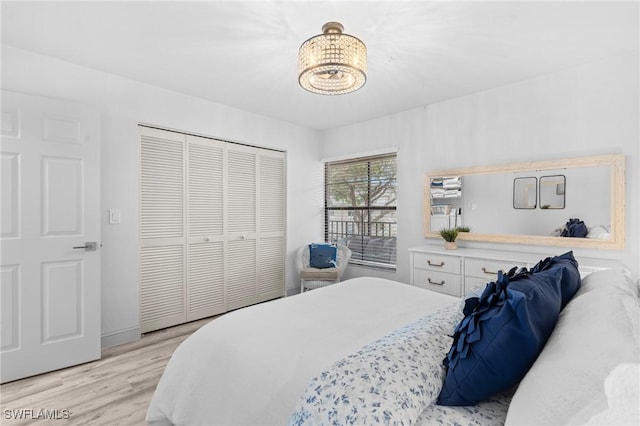 bedroom featuring light wood finished floors and a closet