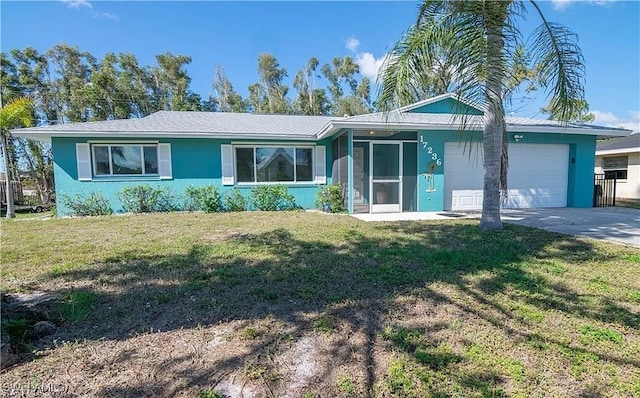 single story home featuring a front lawn and a garage