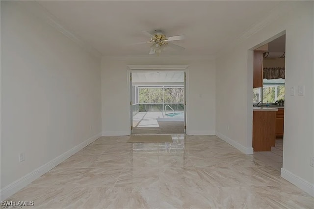 empty room featuring ceiling fan, plenty of natural light, and crown molding