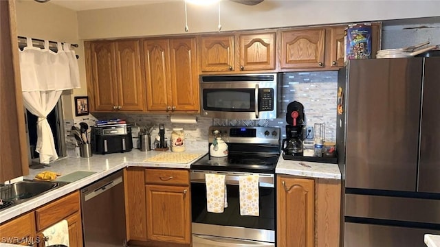 kitchen with appliances with stainless steel finishes and backsplash