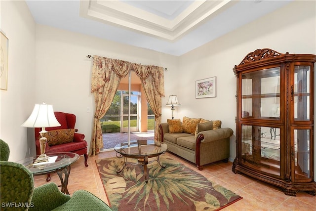 sitting room featuring light tile patterned flooring and a raised ceiling