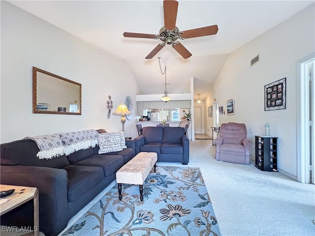 carpeted living room featuring vaulted ceiling and ceiling fan