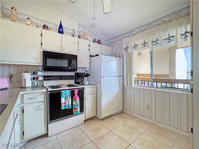 kitchen with white appliances, white cabinets, and light tile patterned flooring