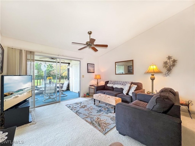 living room featuring ceiling fan, carpet flooring, and vaulted ceiling