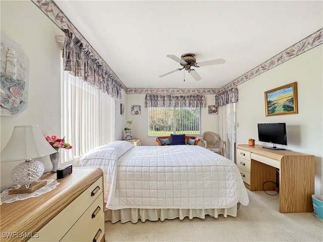 bedroom with ceiling fan and light colored carpet