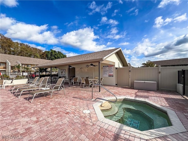 view of pool featuring a patio, ceiling fan, and a hot tub