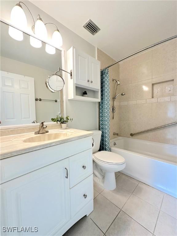 full bath featuring visible vents, toilet, tile patterned floors, shower / bath combination with curtain, and vanity