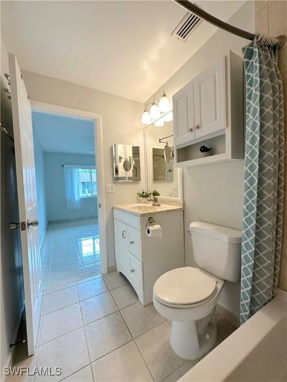 bathroom with tile patterned flooring, toilet, vanity, visible vents, and baseboards