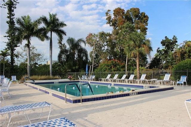 community pool featuring a patio area and fence