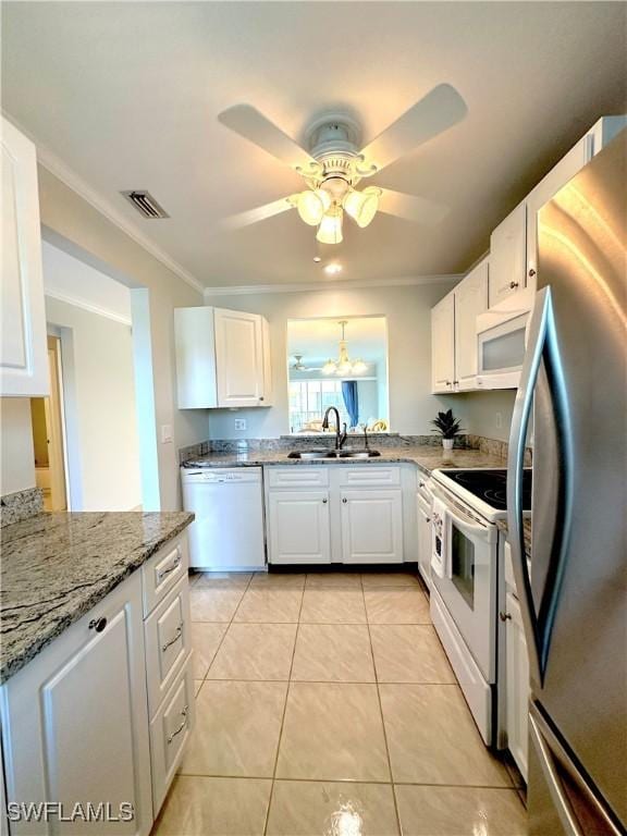 kitchen featuring white appliances, a sink, white cabinetry, crown molding, and a ceiling fan