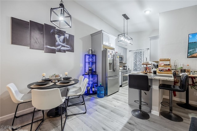 dining space with light wood-type flooring