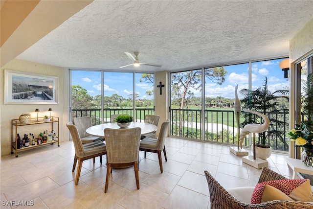 sunroom / solarium with a healthy amount of sunlight and a ceiling fan