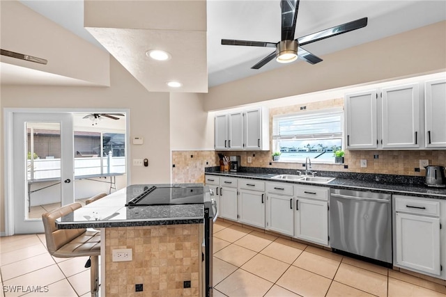 kitchen featuring stainless steel appliances, a sink, and white cabinetry