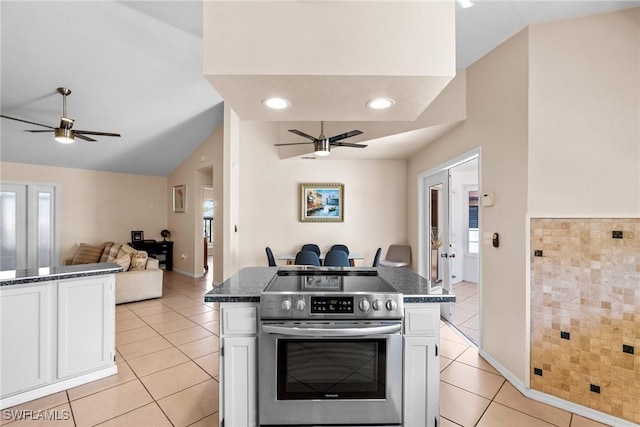 kitchen with white cabinets, stainless steel range with electric cooktop, ceiling fan, and light tile patterned flooring