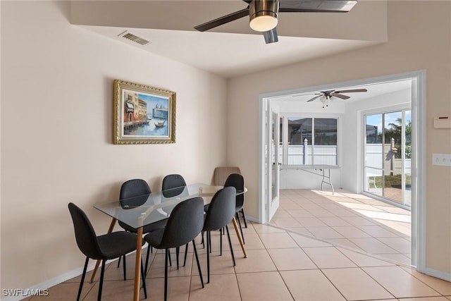 dining room with light tile patterned floors, baseboards, visible vents, and ceiling fan