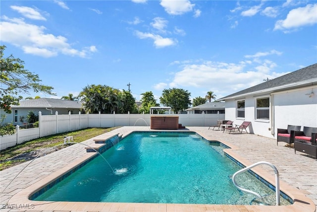 view of pool with a hot tub, a fenced in pool, a fenced backyard, and a patio