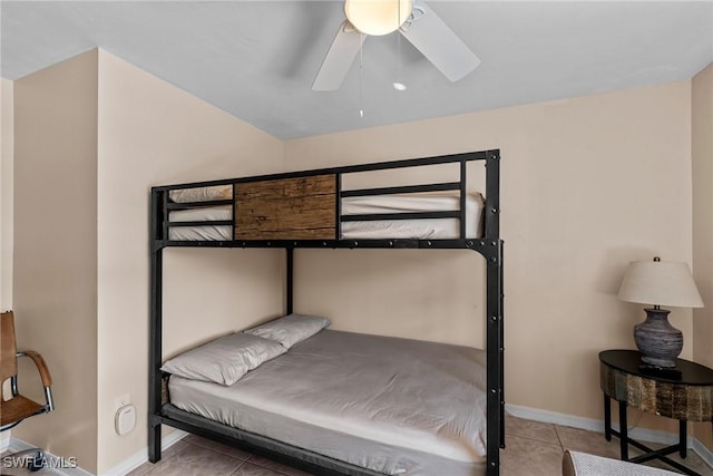 bedroom with ceiling fan, baseboards, and light tile patterned floors