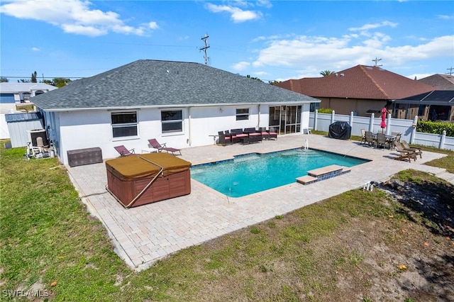 view of pool with a fenced in pool, a yard, a patio, a hot tub, and a fenced backyard