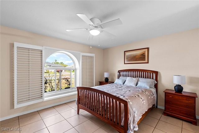 bedroom featuring ceiling fan, baseboards, and light tile patterned flooring