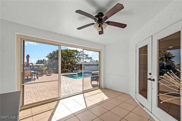 sunroom / solarium with french doors and ceiling fan