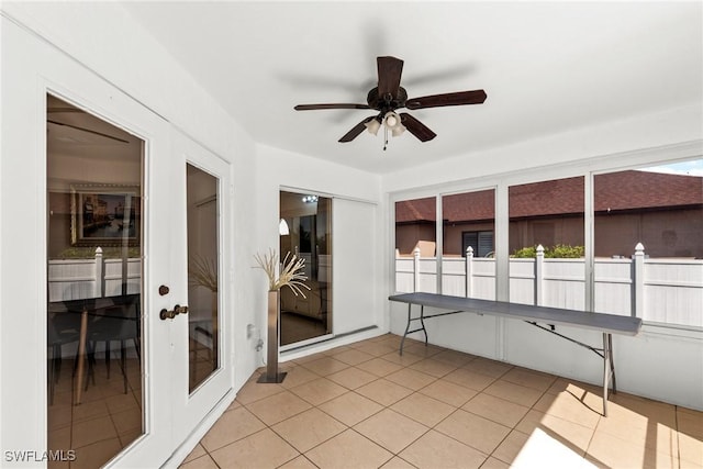 sunroom / solarium featuring ceiling fan and french doors