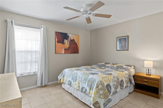 tiled bedroom featuring ceiling fan