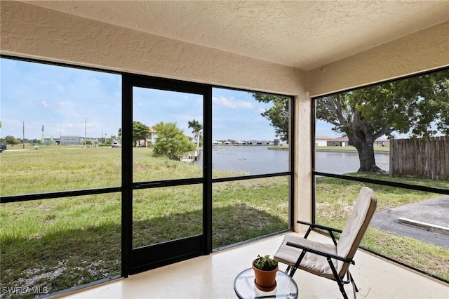 sunroom / solarium featuring a water view