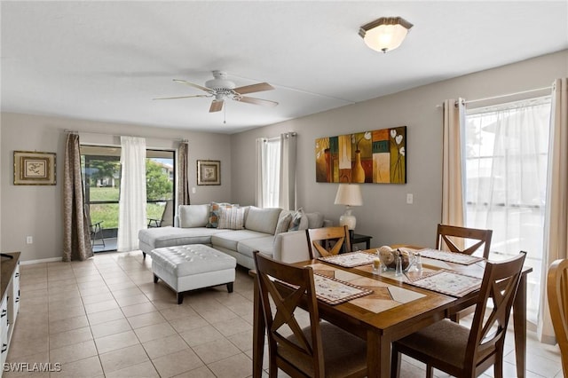 dining space with ceiling fan and light tile patterned floors