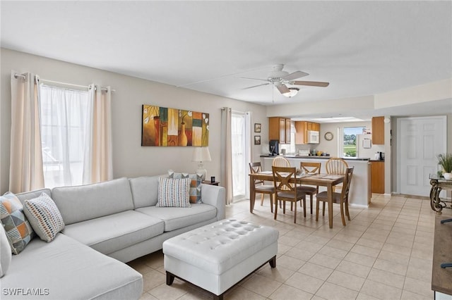 tiled living room featuring ceiling fan