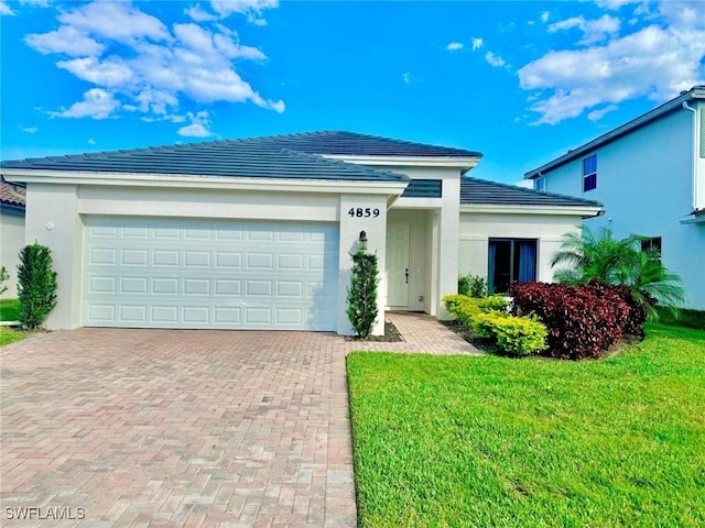 view of front of house with a front lawn and a garage