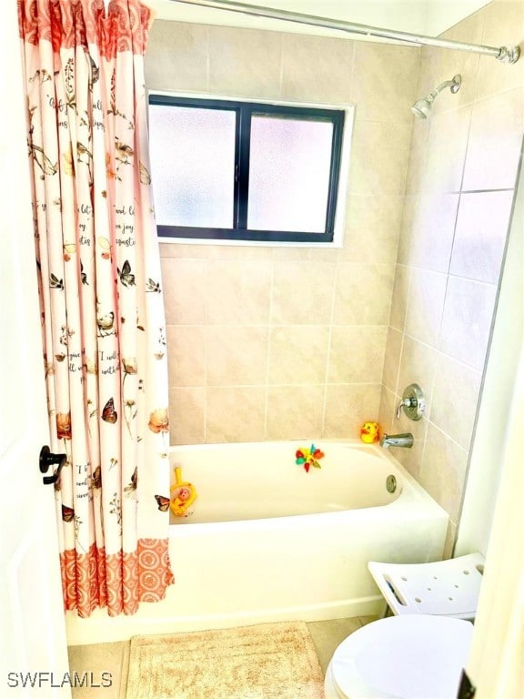 bathroom featuring tile patterned floors, shower / bath combo, and toilet