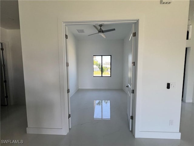 spare room with a ceiling fan and visible vents