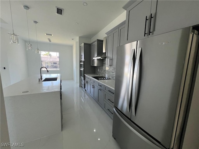 kitchen featuring visible vents, appliances with stainless steel finishes, a sink, and gray cabinetry