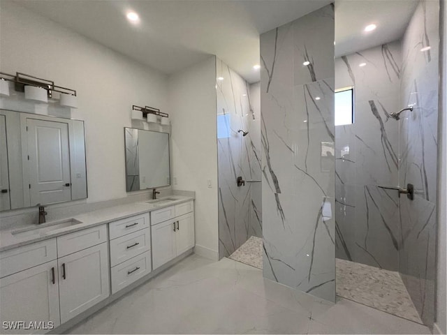 full bathroom with double vanity, marble finish floor, a marble finish shower, and a sink