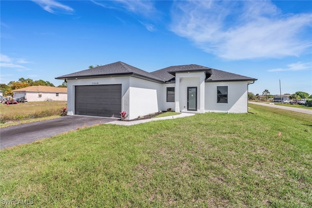 view of front of house featuring a garage and a front lawn