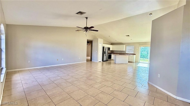 unfurnished living room with light tile patterned flooring, lofted ceiling, and ceiling fan