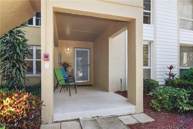 view of exterior entry featuring stucco siding