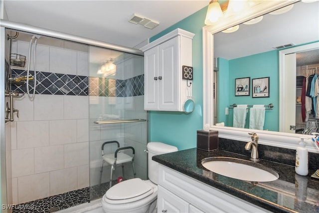 full bathroom with visible vents, a shower stall, and toilet