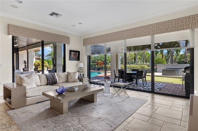 living room featuring stone tile floors, recessed lighting, visible vents, and ornamental molding