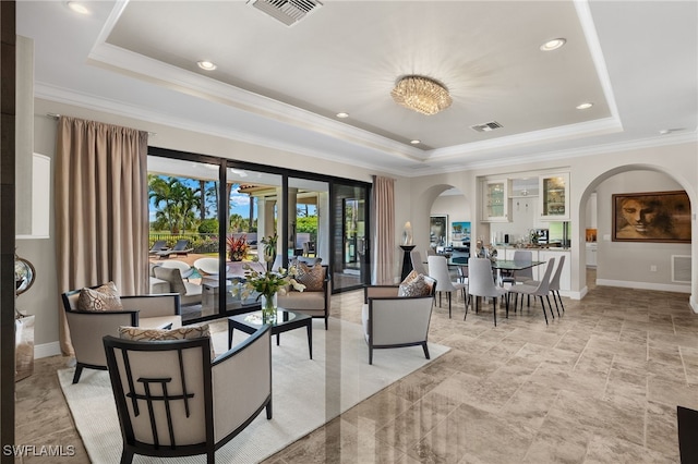 living room with a raised ceiling and visible vents