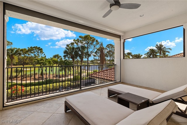 view of patio with a balcony and a ceiling fan