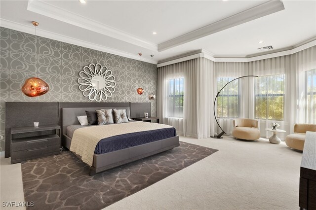 bedroom with crown molding, wallpapered walls, a raised ceiling, and carpet