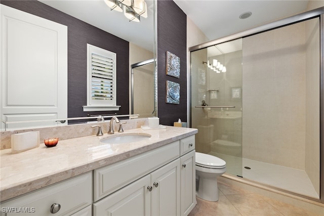 full bathroom featuring vanity, tile patterned floors, toilet, and a stall shower