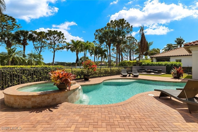 view of swimming pool with an in ground hot tub, fence, a fenced in pool, and a patio