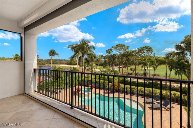 balcony featuring a pool with connected hot tub