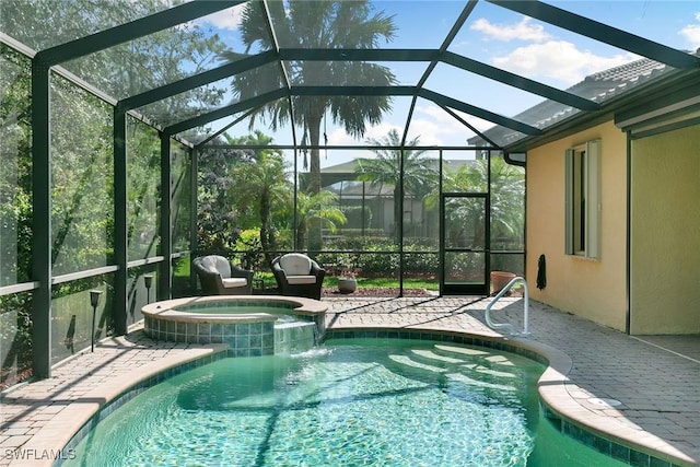 view of pool featuring an in ground hot tub, a patio, and a lanai