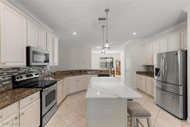 kitchen with stainless steel appliances, pendant lighting, a breakfast bar, a center island, and dark stone countertops