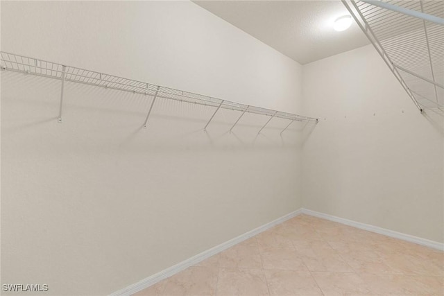 walk in closet featuring light tile patterned floors