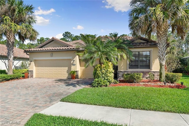 mediterranean / spanish house featuring a front yard and a garage